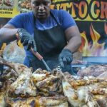 Woman Chef Alone Masters a Huge Grill of Meat. Italy Street Food